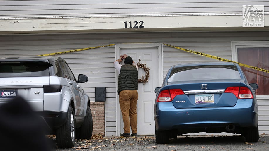 Investigator tapes the door