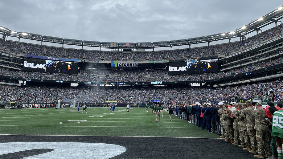 NEW YORK - Servicemembers from all five branches participate in a ceremony  during the halftime show at the New York Giants vs. the Philadelphia Eagles  Military Appreciation Game at MetLife Stadium in