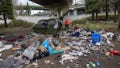 SEATTLE, WASHINGTON - MARCH 13: Andrea Suarez dismantles a tent as garbage lies piled at a homeless encampment on March 13, 2022 in Seattle, Washington. The accumulation of garbage at such sites has become a major issue in Seattle as the city tries to move the unhoused out of shared public spaces. Suarez is the executive director of We Heart Seattle, a non-profit that stages trash cleanups across the city. According to a recent report commissioned by Seattle Councilmember Andrew Lewis, the COVID-19 pandemic put undue pressure on the city's shelter system and delayed funds for new housing, leading to an increase in homelessness.