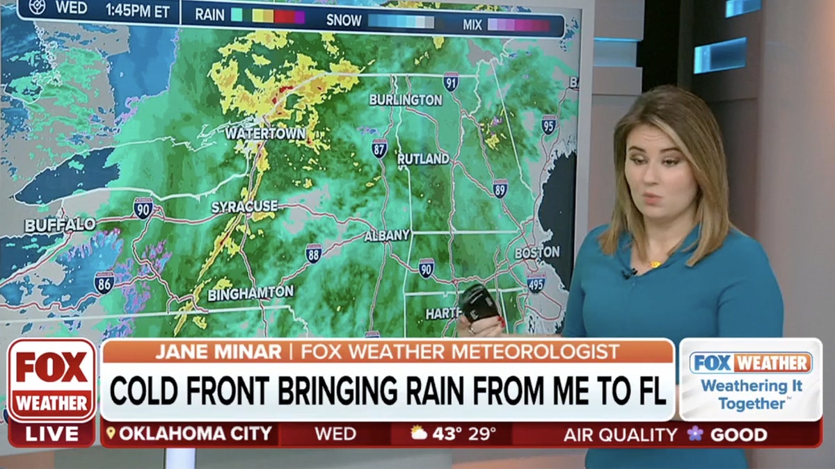 Fox Weather reporter in front of weather graphic showing cold front
