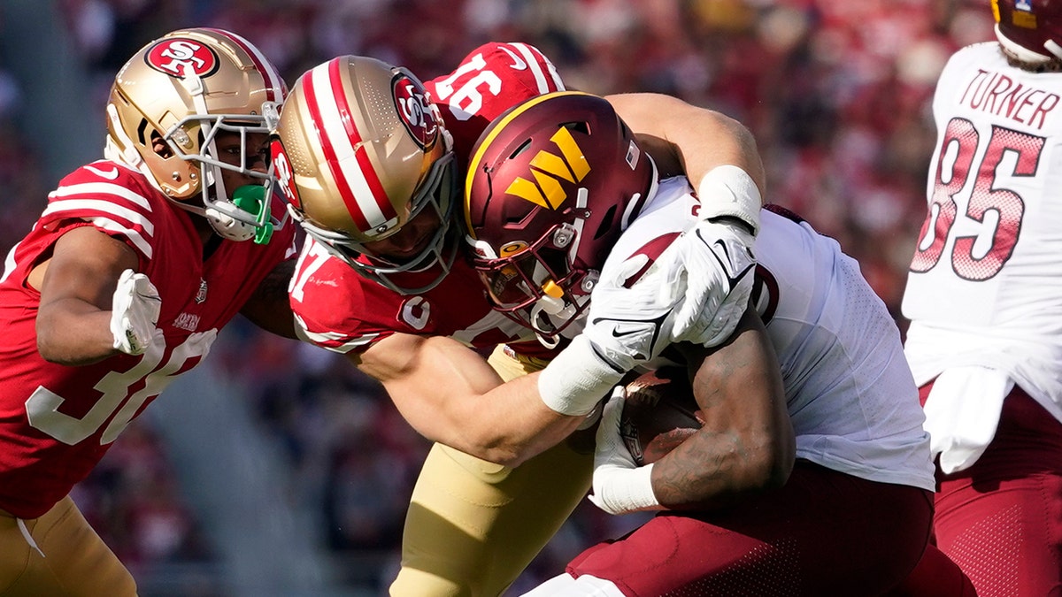 Nick Bosa tackles a player