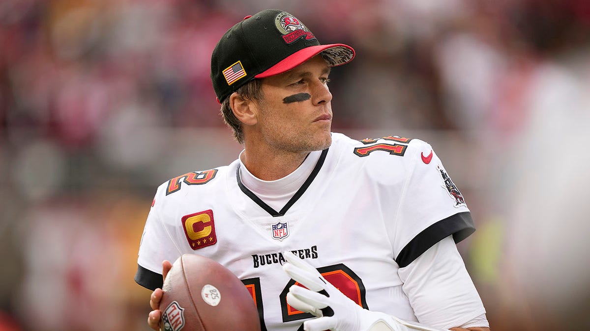 Tom Brady warms up before a game