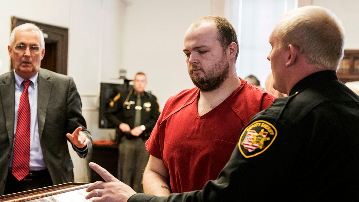 George Wagner IV handcuffed and in jumpsuit in court