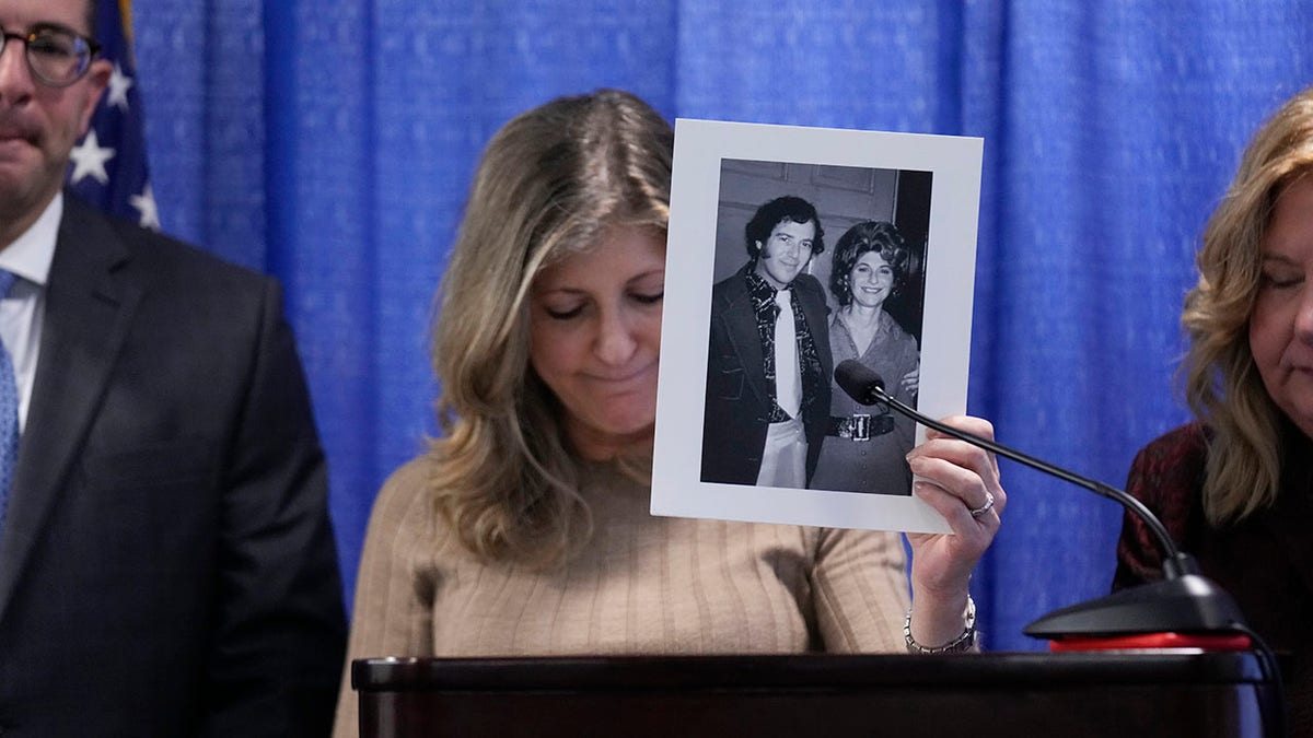 Daughter of Torso killer's victim holds up photo of her parents