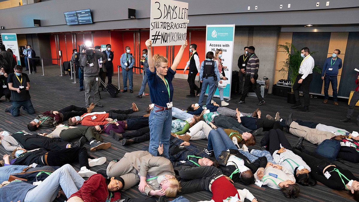 Protesters lie in a circle