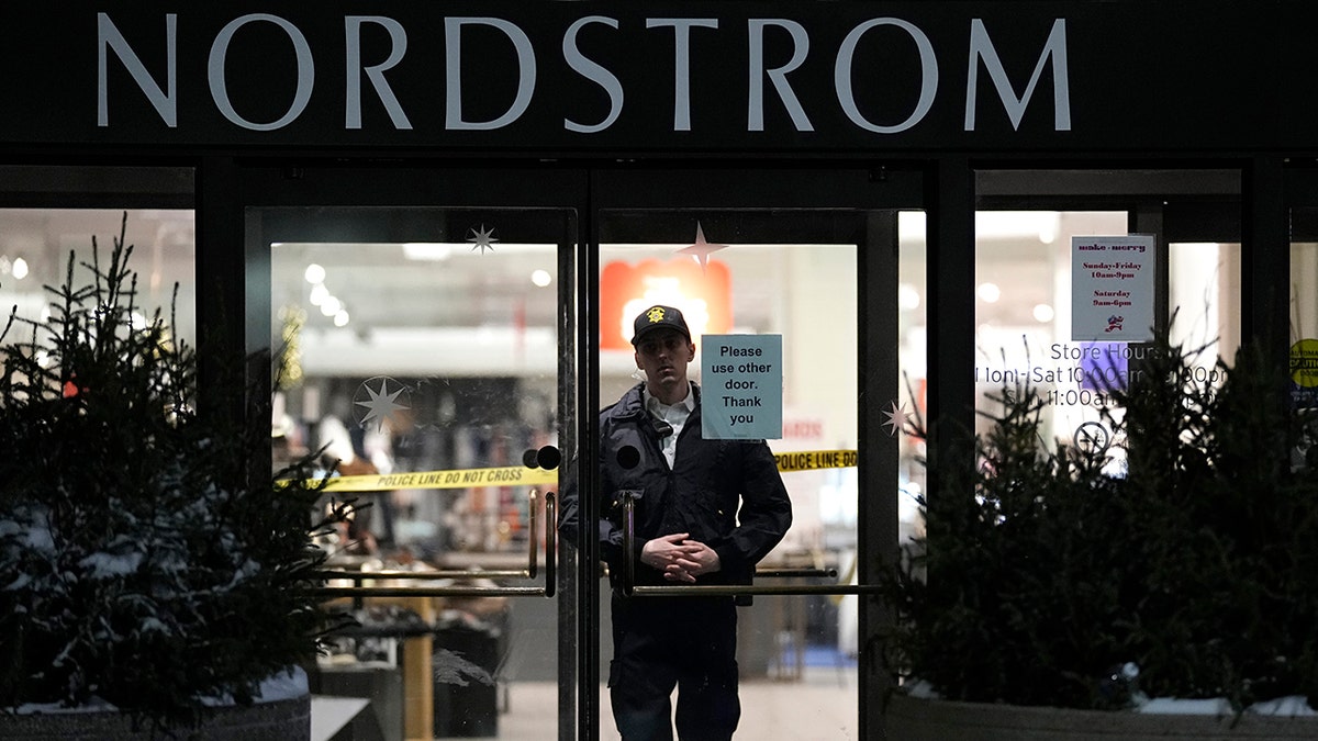 A photo of a police officer behind a glass door