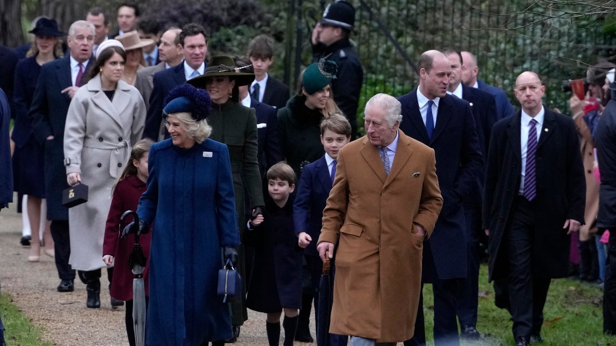 Prince Andrew can be pictured walking behind his two daughters and alongside Prince Edward, behind The King and Queen Consort