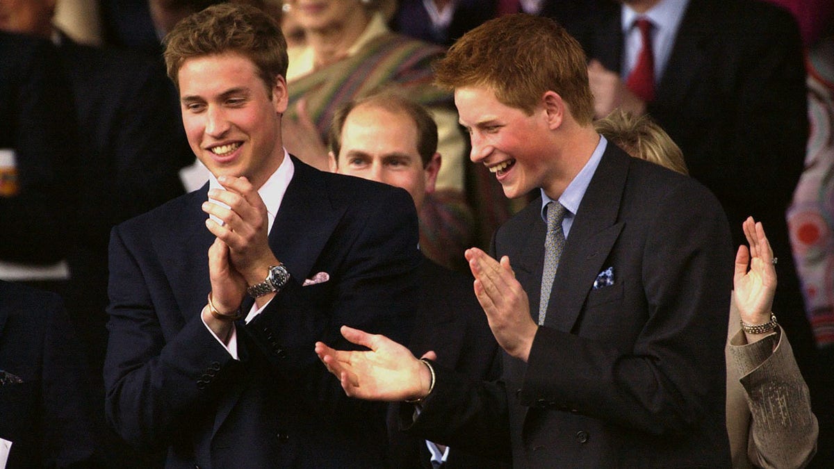 Prince William and Prince Harry as children sharing a laugh