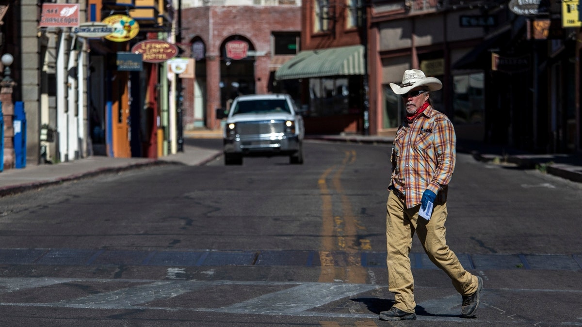 A man walks across a Cochise County street