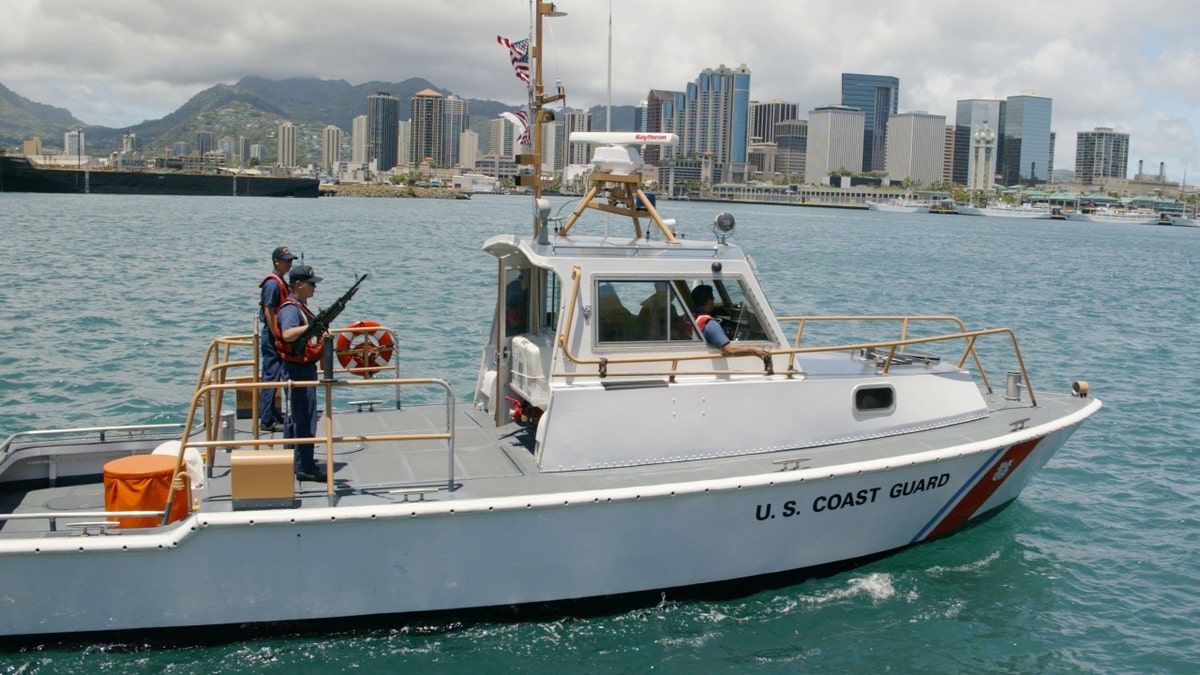 A U.S. Coast Guard boat patrols Honolulu Harbor