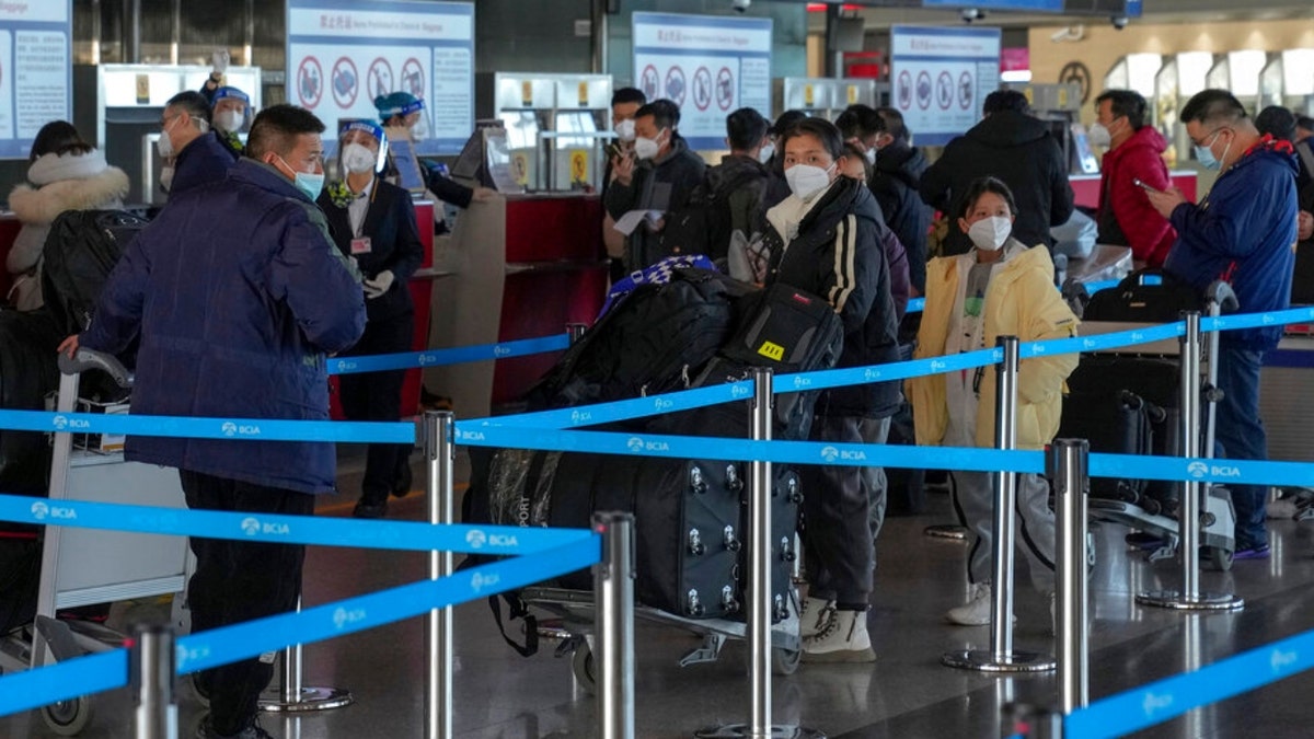 Masked travellers with luggage