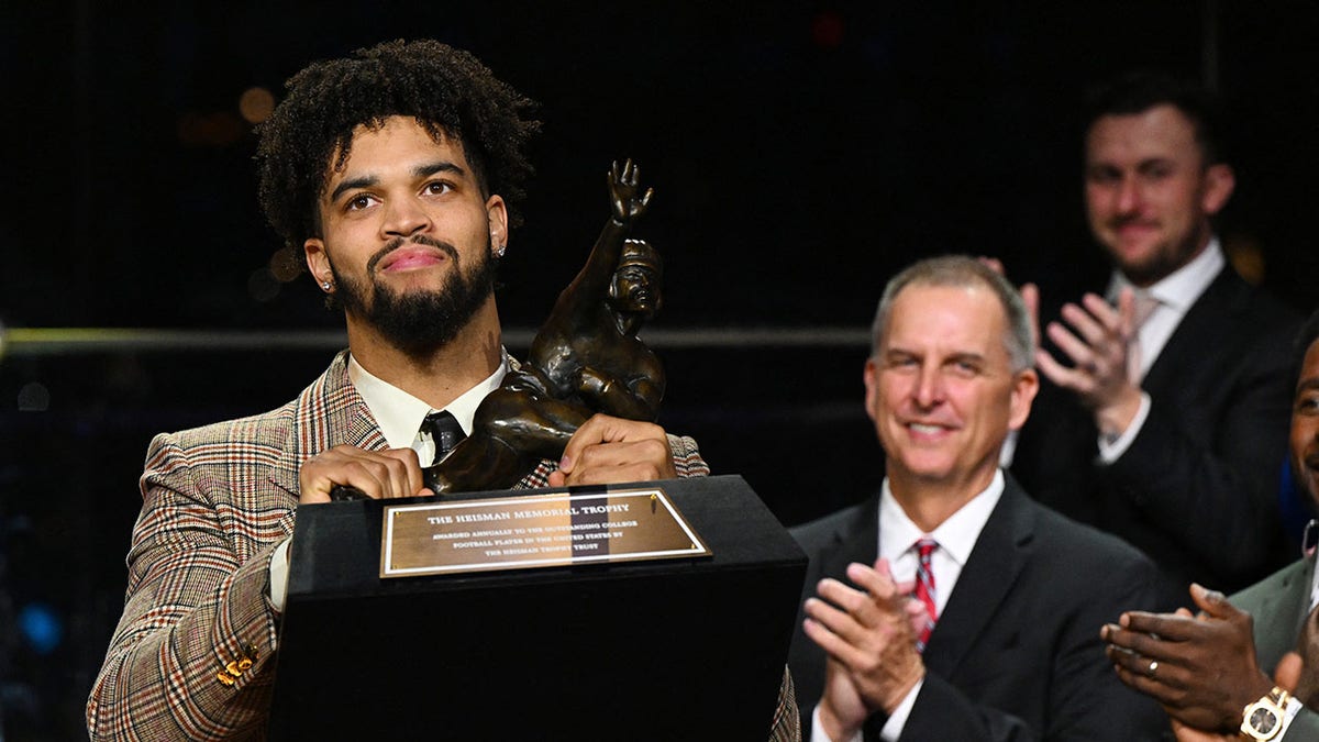 Caleb Williams reacts after winning the Heisman Trophy