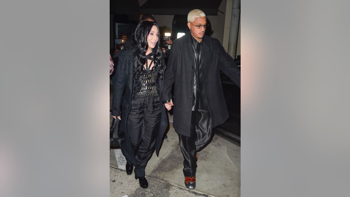 Cher and her boyfriend Alexander "A.E." Edwards walking and holding hands