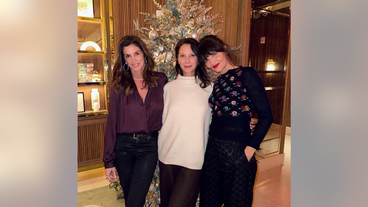 Cindy Crawford, Christy Turlington and Helena Christensen pose together during a holiday celebration