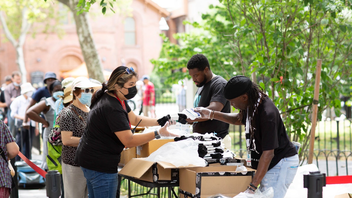 Volunteers for City Relief hand out socks