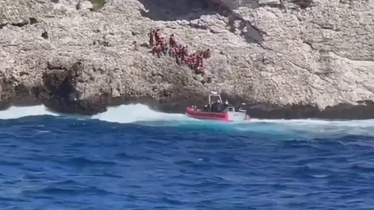 Coast Guard vessel rescues people from cliff