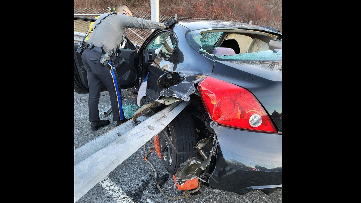 First responders inspect vehicle at crash scene in Connecticut