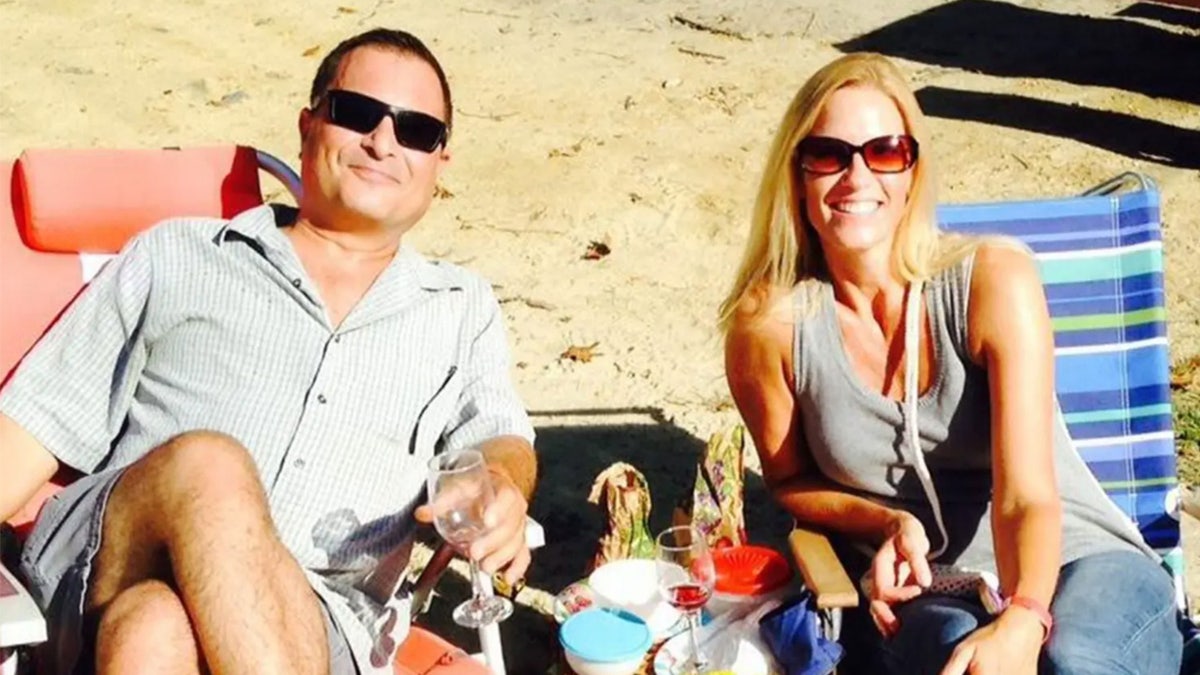 David and Marylue Wigglesworth lounge in beach chairs in the sand.