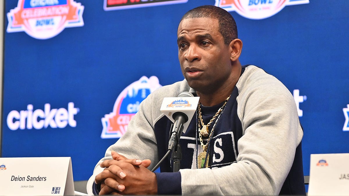 Coach Deion Sanders speaks with the media