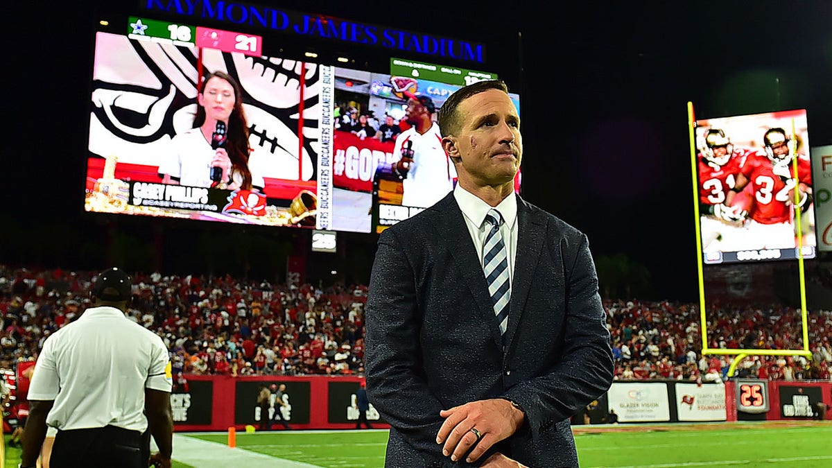 Drew Brees stands on the sidelines