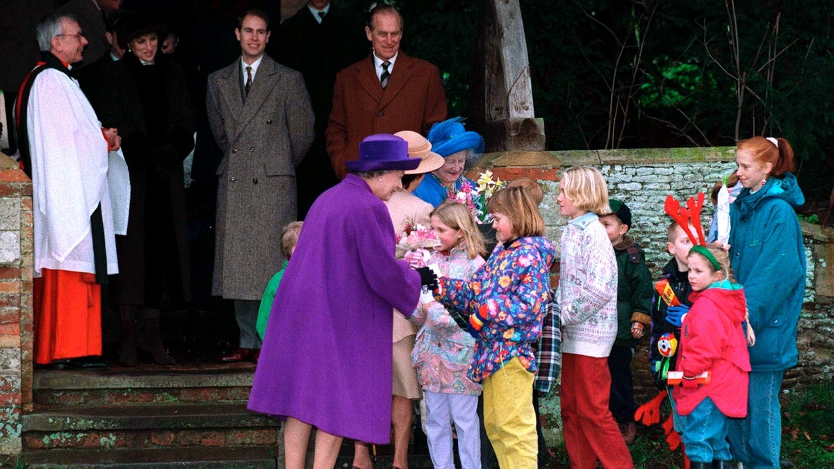 Queen Elizabeth II receiving flowers on Dec. 25, 1994