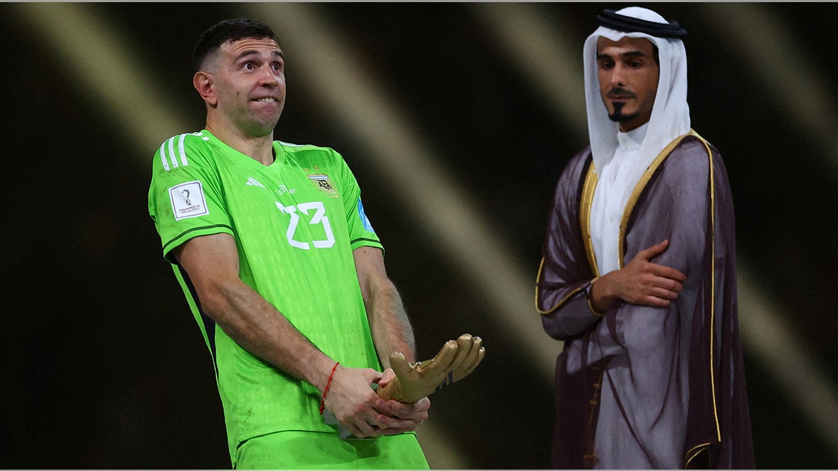 Emiliano Martinez points the trophy near his crotch