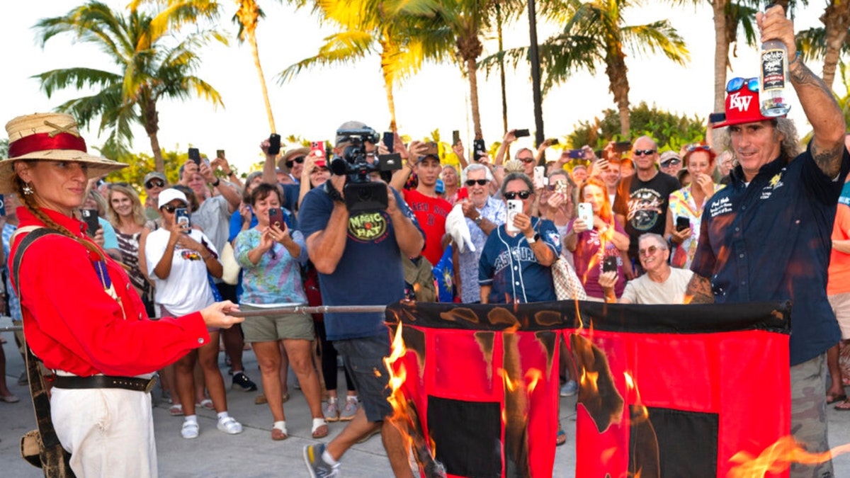 A flag burns to mark the end of the Atlantic hurricane season