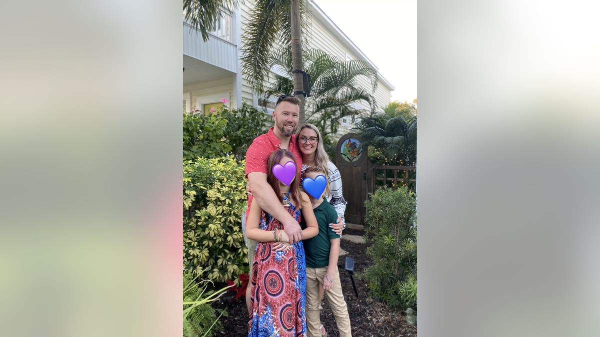 The Steele family taking a photo outdoors.