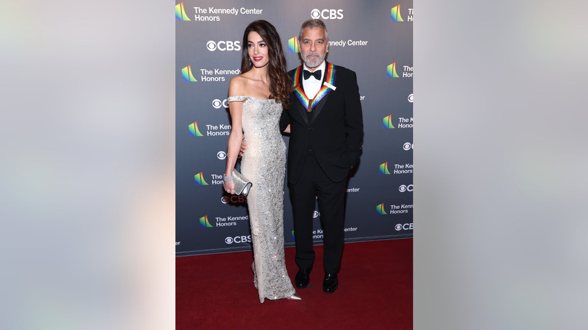 Amal Clooney and George Clooney pose together at Kennedy Center Honors