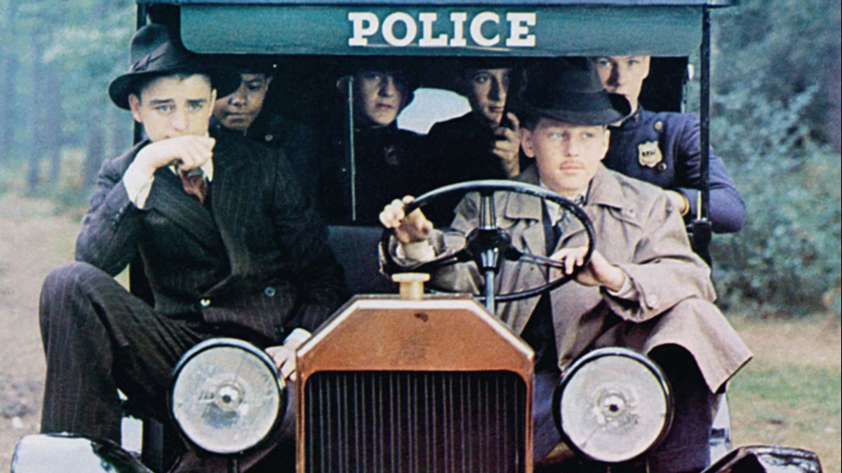 Bugsy Malone characters driving the famous golf-cart/bike like car