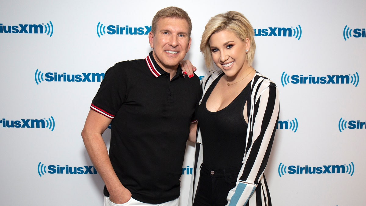 Todd and Savannah Chrisley pose together on the carpet
