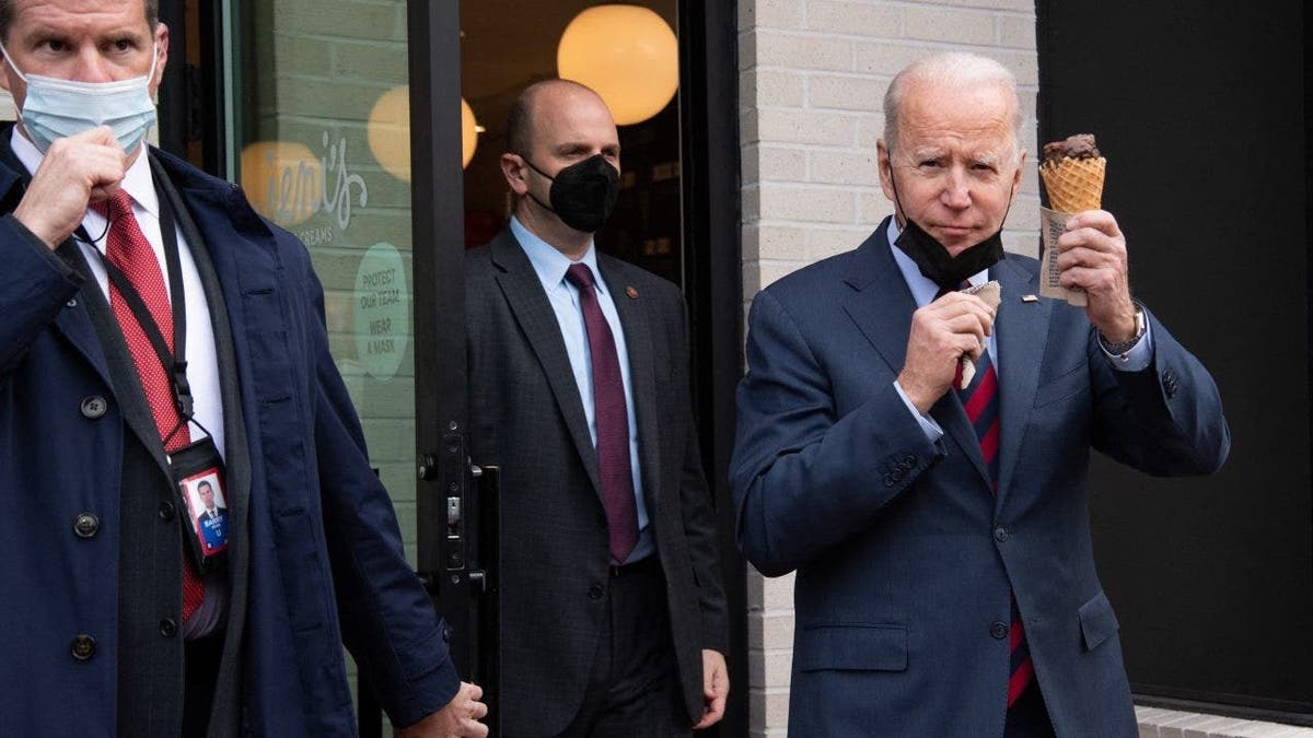 US President Joe Biden carries an ice cream cone