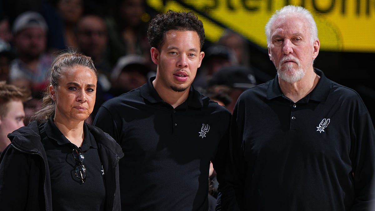 Becky Hammon and Greg Popovich during an NBA game