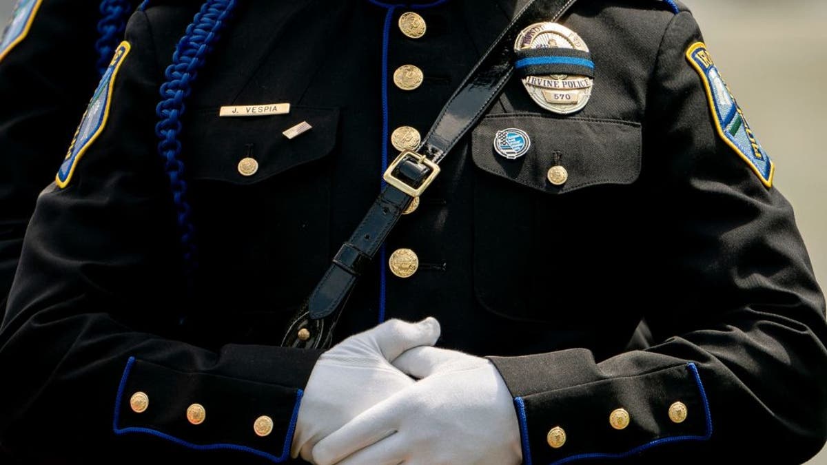 Police officer in mourning crosses hands