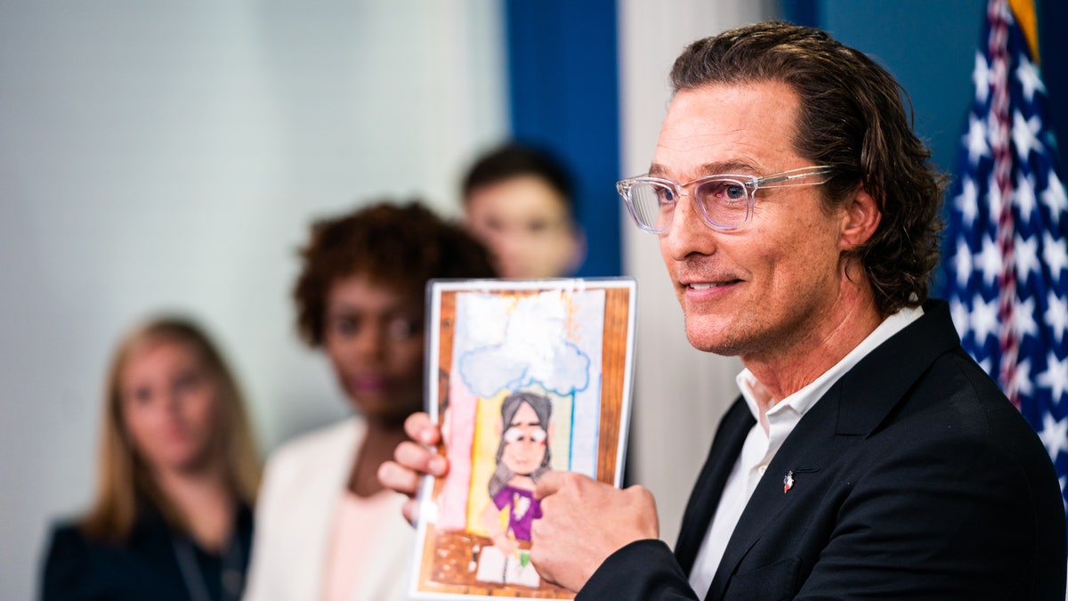 Matthew McConaughey holds up artwork while speaking at the White House about the Uvalde victims