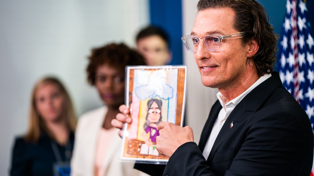 Matthew McConaughey holds up artwork while speaking at the White House about the Uvalde victims