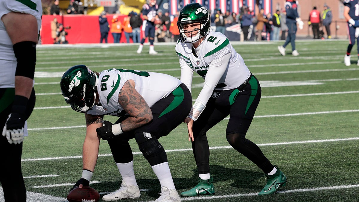 Zach Wilson and Connor McGovern before a game against the Patriots