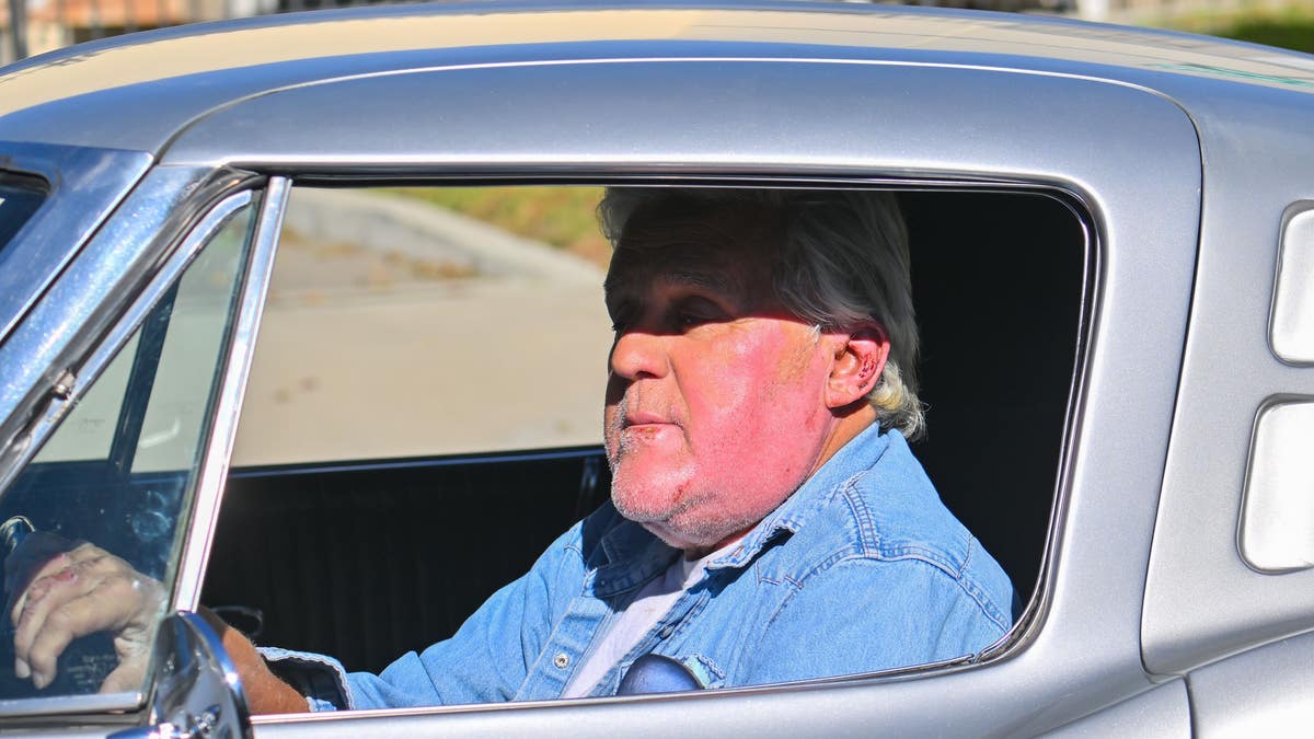 Jay Leno drives classic car after being released from hospital for face burns