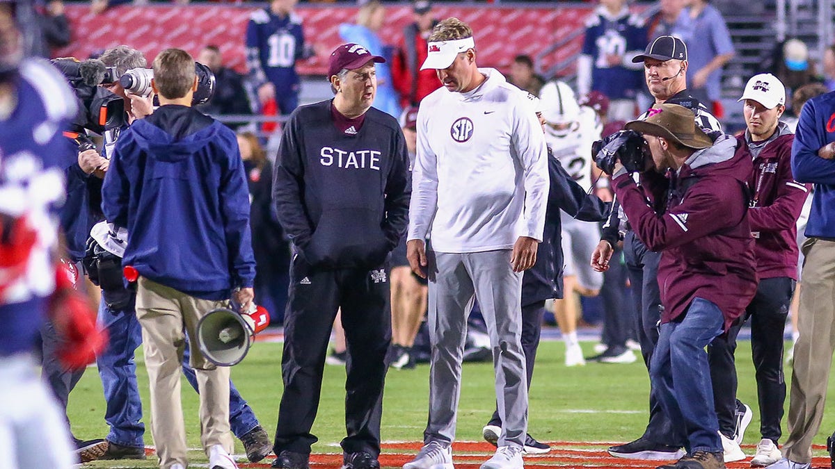 Mike Leach and Lane Kiffin talk before a game