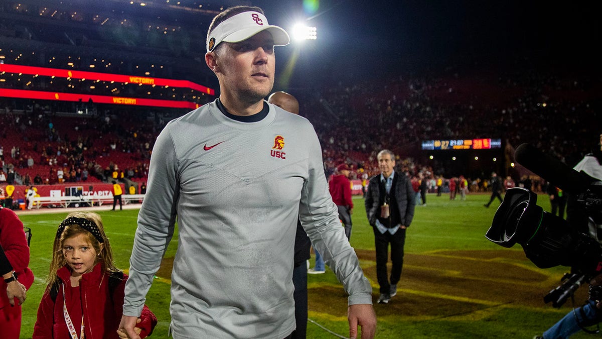 Lincoln Riley on the field after beating Notre Dame