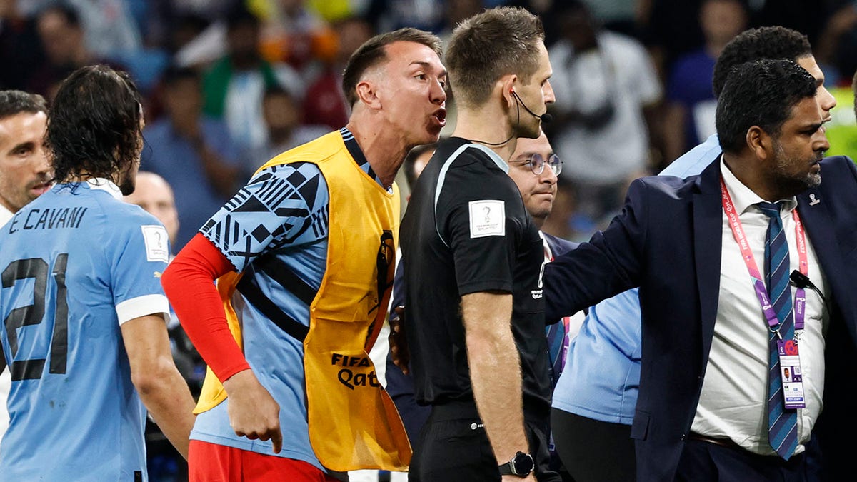 A player from Uruguay lashes out at a game official after the match