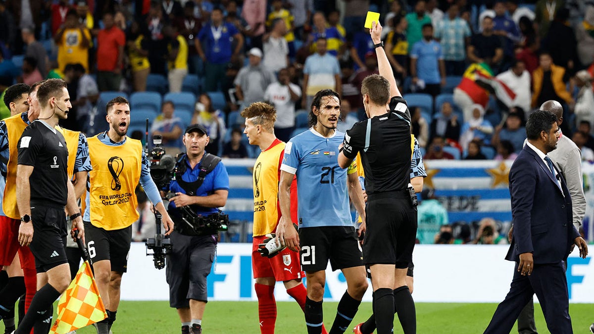 German referee Daniel Siebert gives out a yellow card