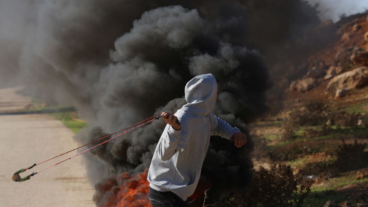 Palestinian man aims catapult