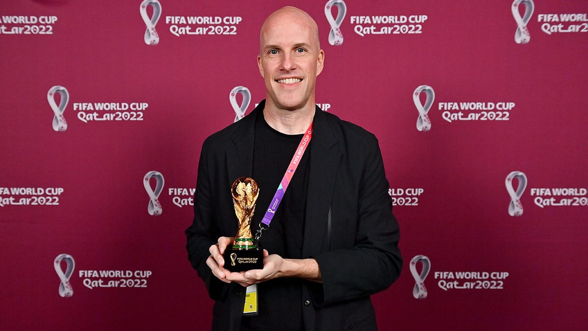 Grant Wahl with a world cup replica trophy