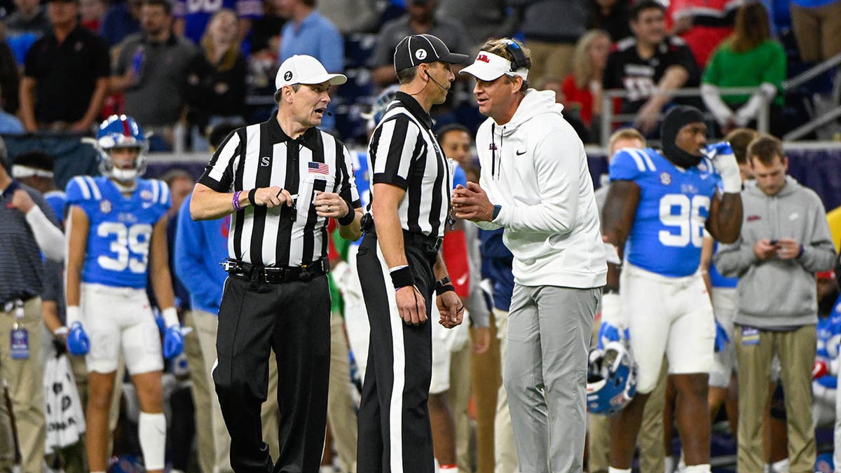 Lane Kiffin talks with officials during the Texas Bowl game