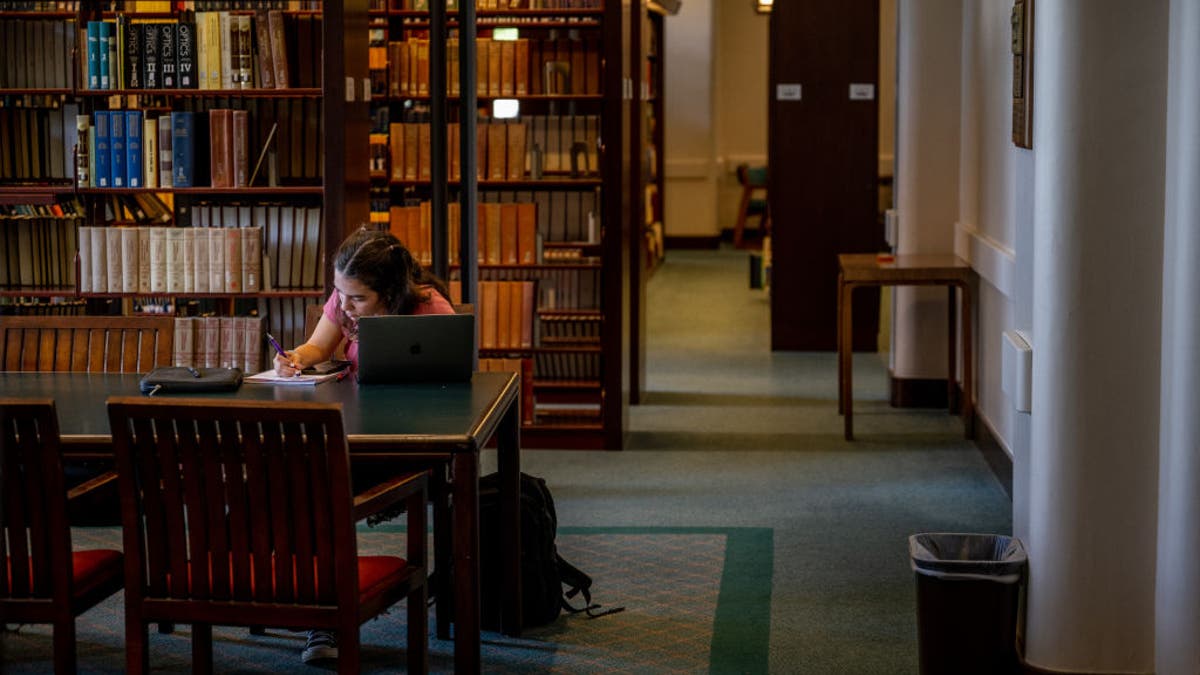 student in library