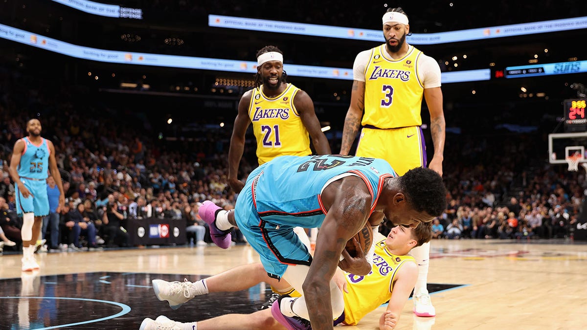 Deandre Ayton falls to the floor after being shoved