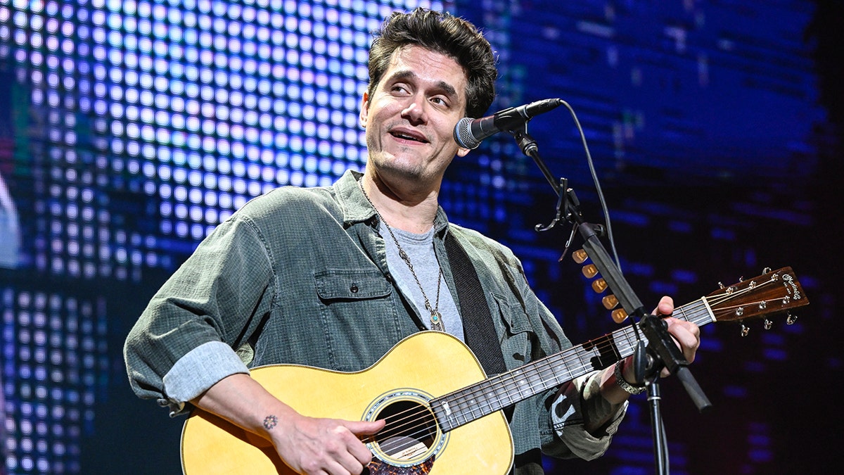 John Mayer plays the guitar on stage in California