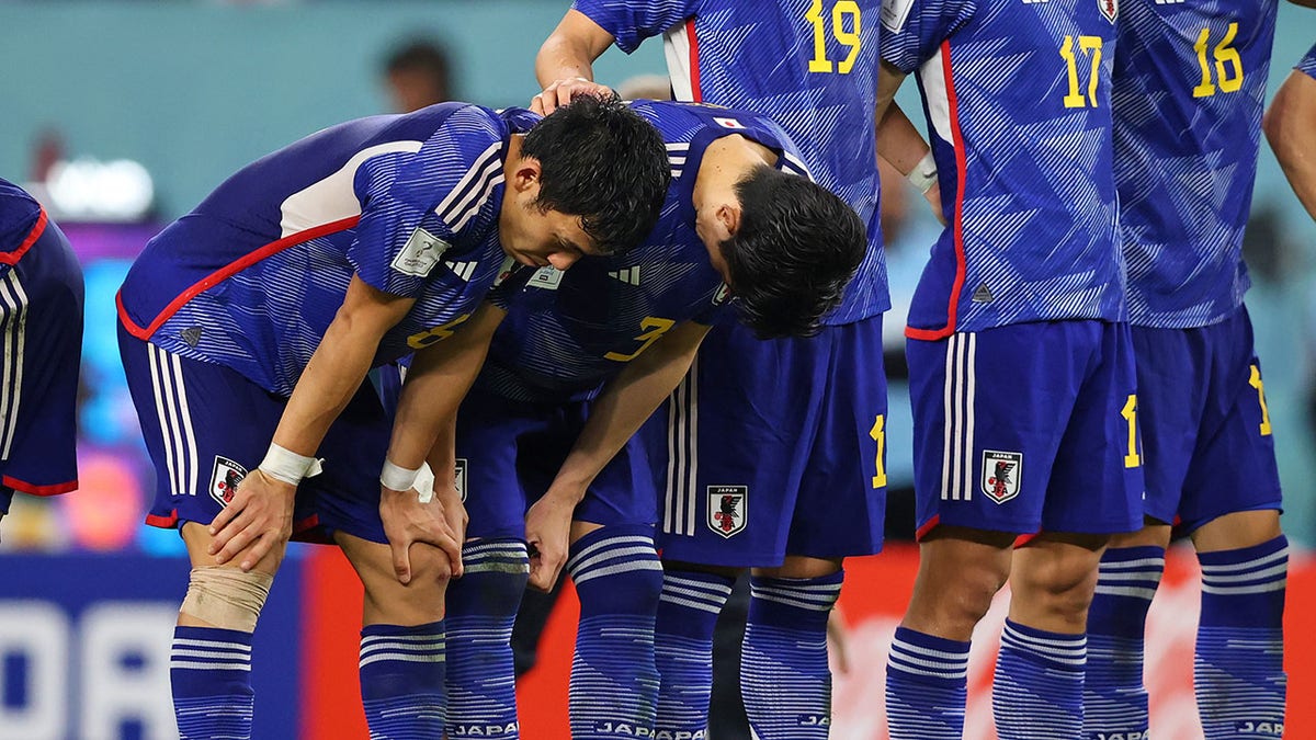 Japan players react during a shootout against Croatia