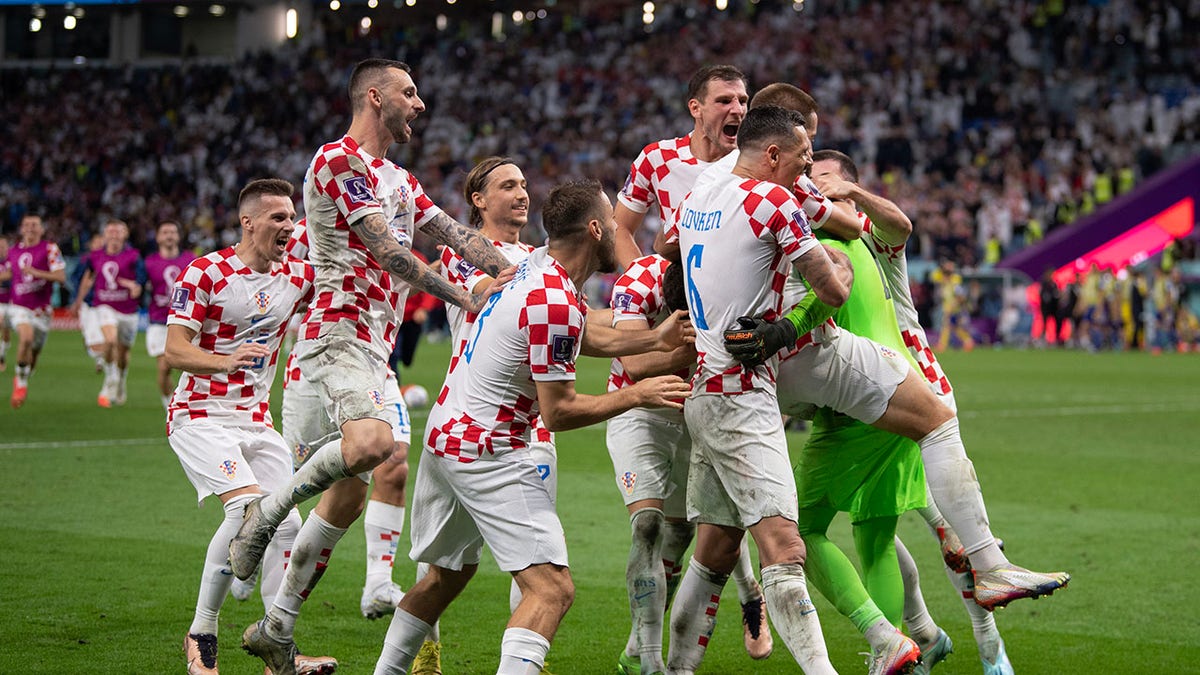 Croatia players celebrate beating Japan in a shootout